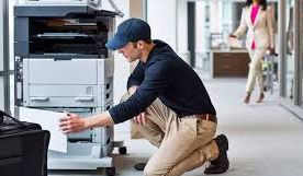 technicien réparant un photocopieur